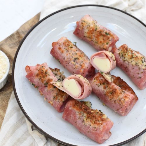 Air fryer crispy ham and cheese bites on a white plate.