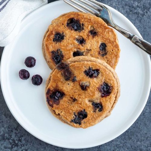 Blueberry Almond Pancakes on a white plate.