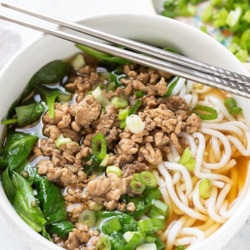 Pork and Spinach Noodle Soup in a white bowl.