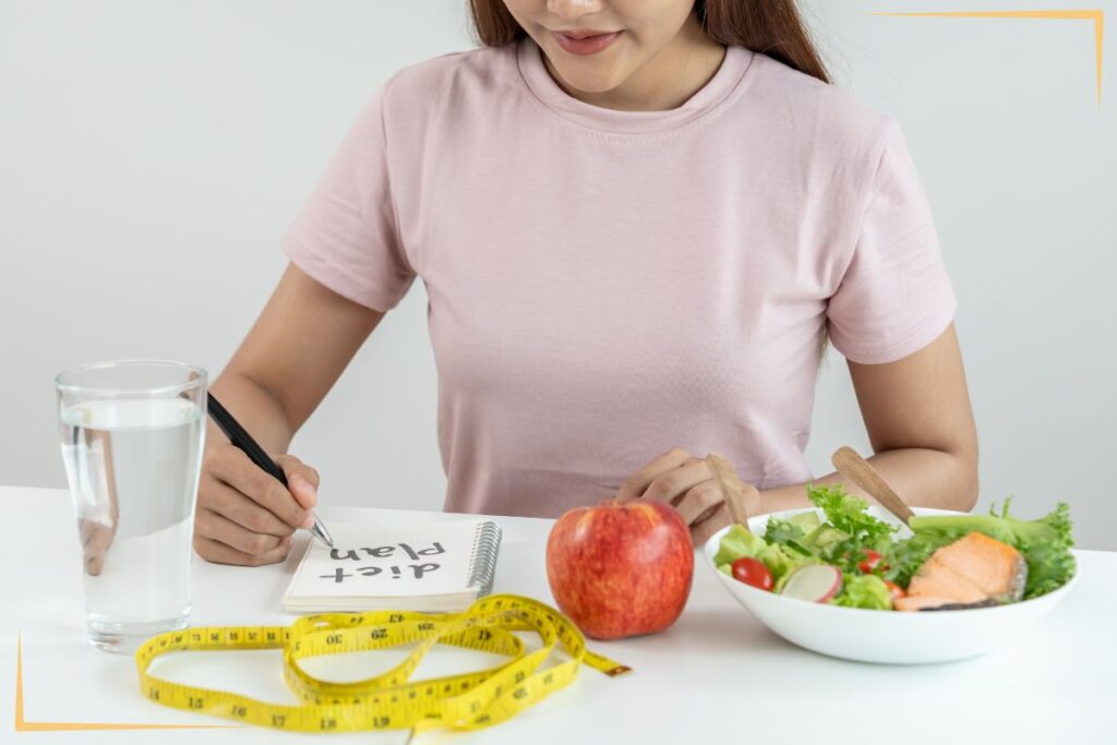 A woman eating food at a table.