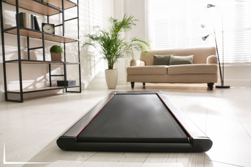 A picture of a walking pad in a living room.