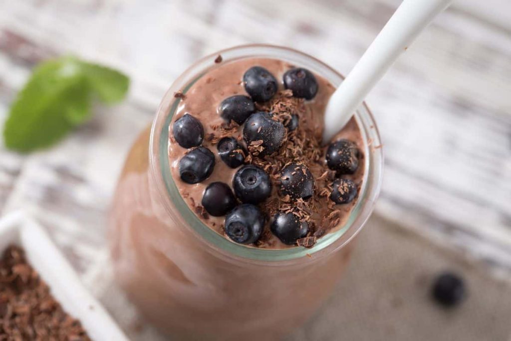 A chocolate shake with berries on top.