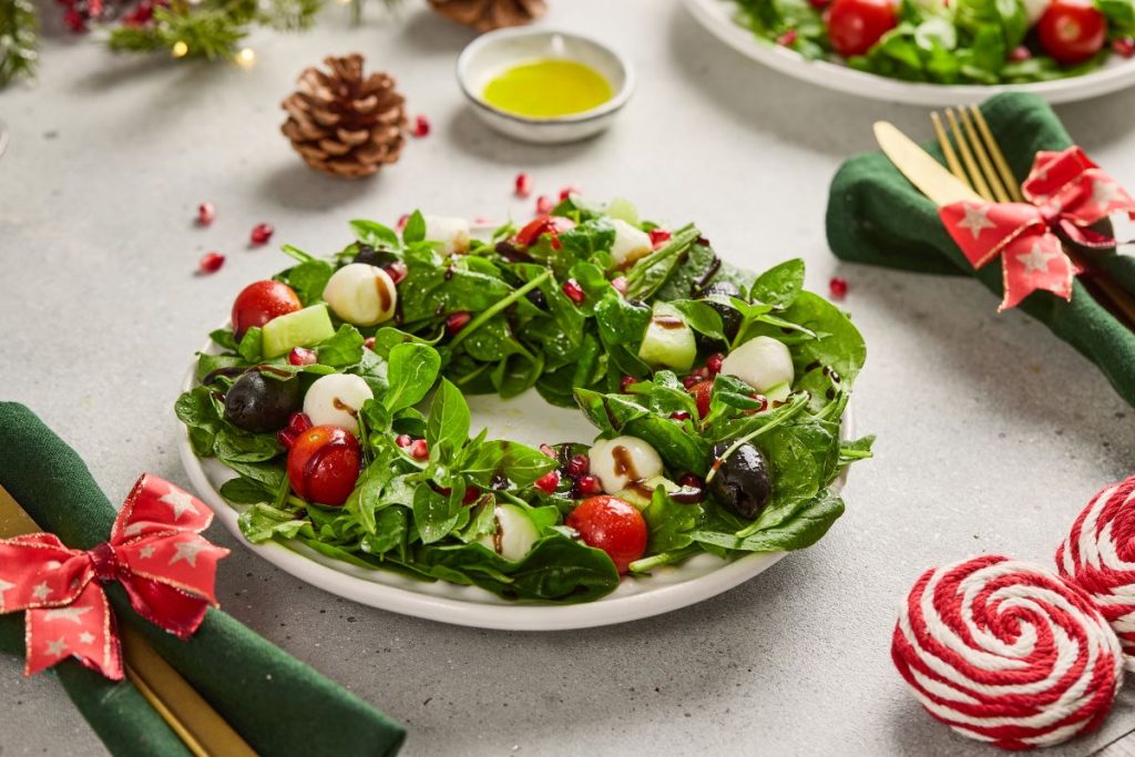 A Christmas wreath salad on a white table.