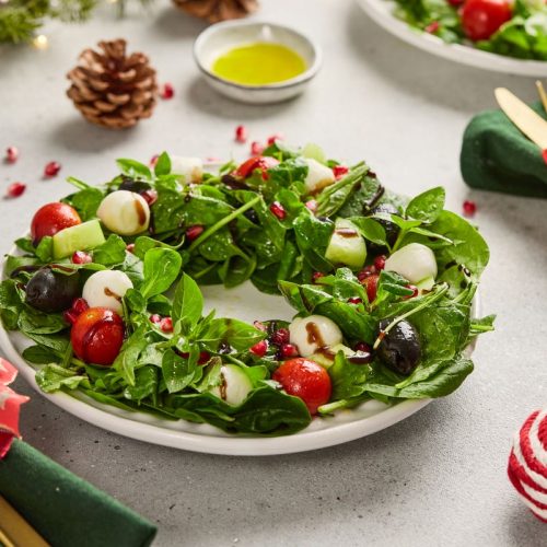 A Christmas wreath salad on a white table.