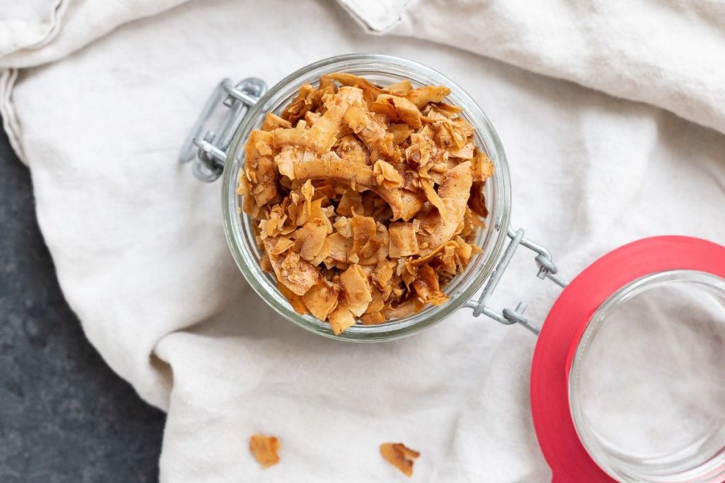 Cinnamon coconut chips in a mason jar.