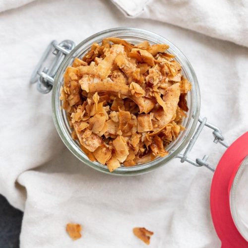 Cinnamon coconut chips in a mason jar.