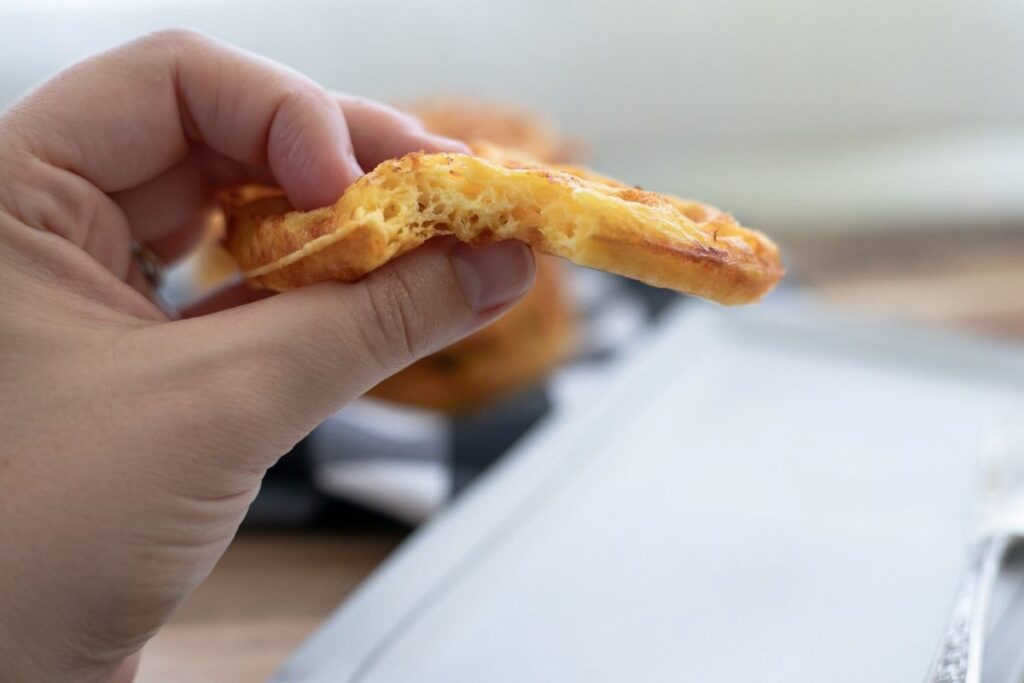 A hand holding a Keto Chaffles.