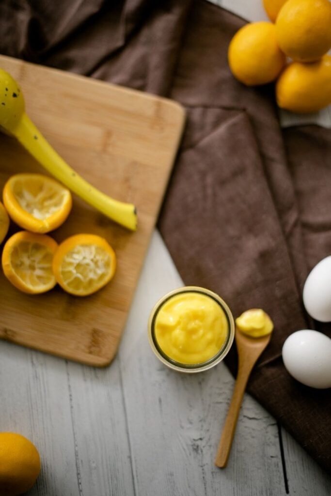 Lemon Curd in a mason jar with a spoon.